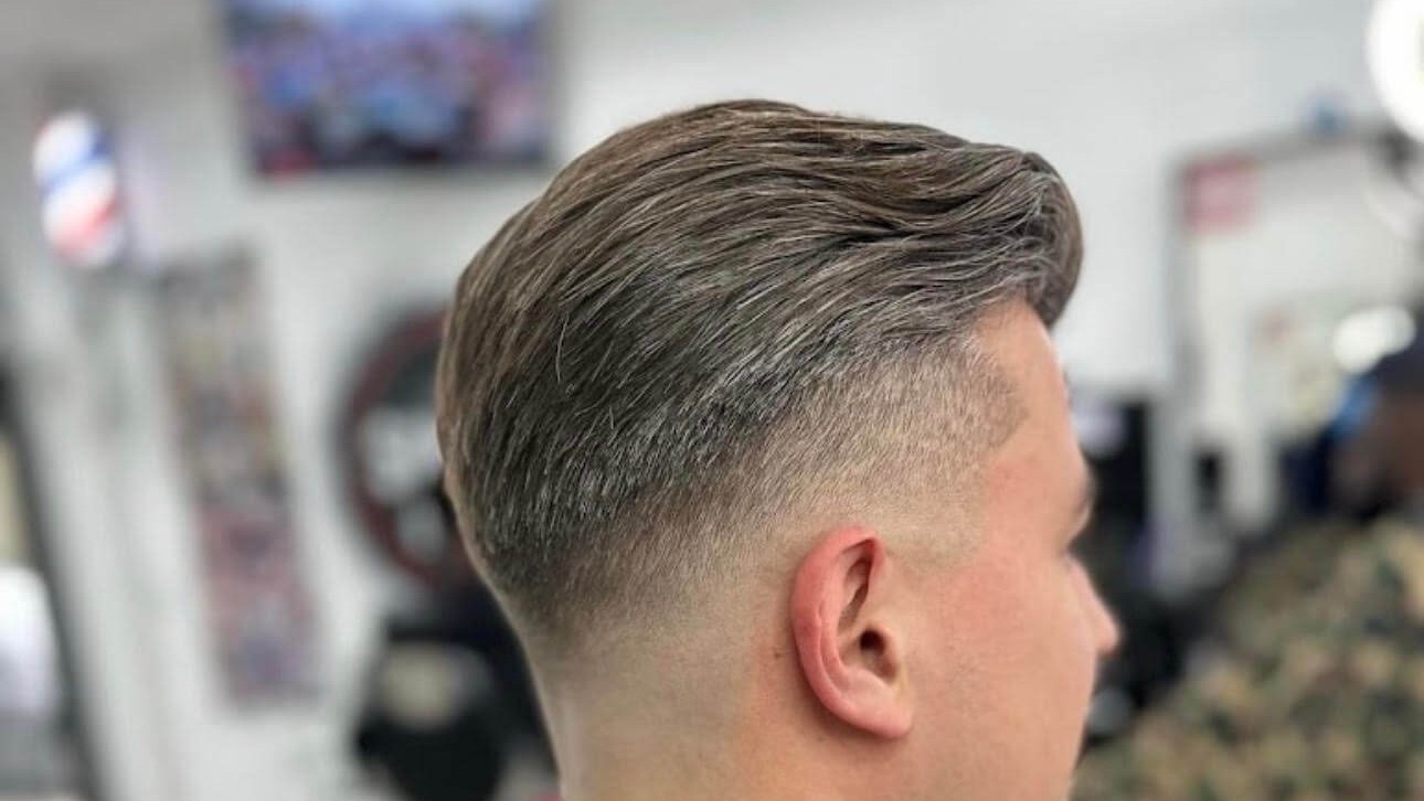 Client getting a skin fade haircut in the shop